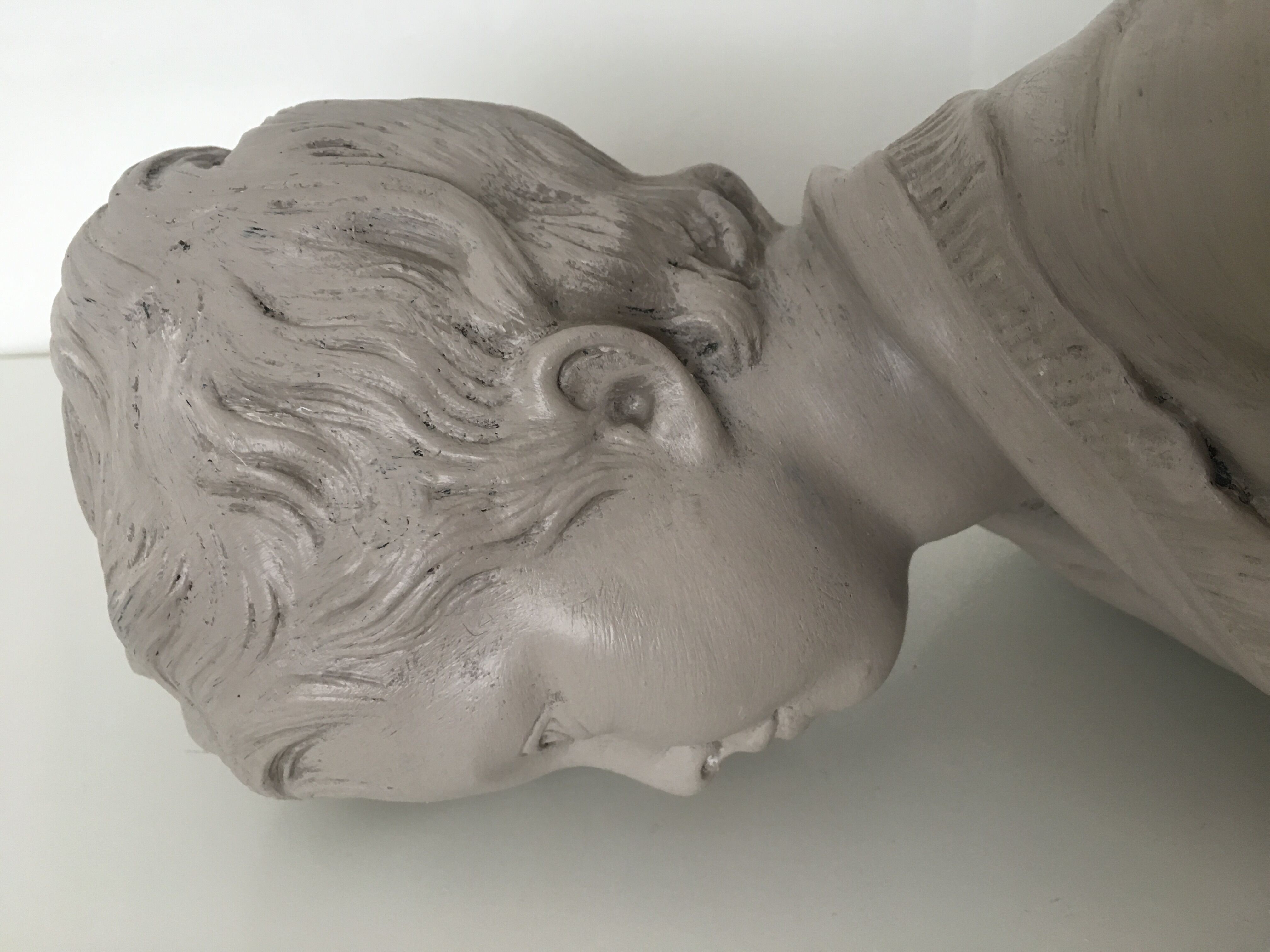 Cherub bust in platter