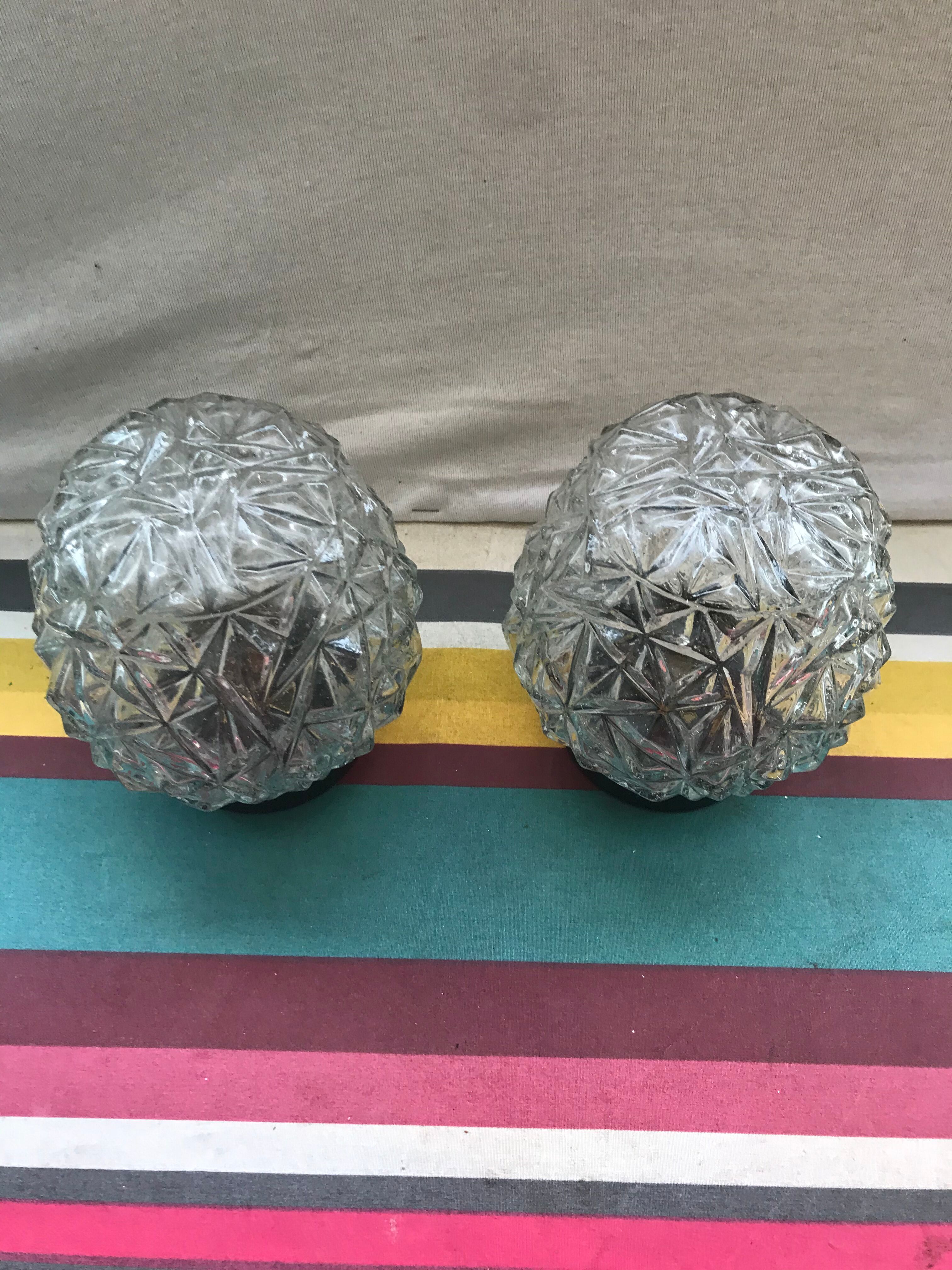 Old pair of glass moulded wall sconces with vintage black metal support