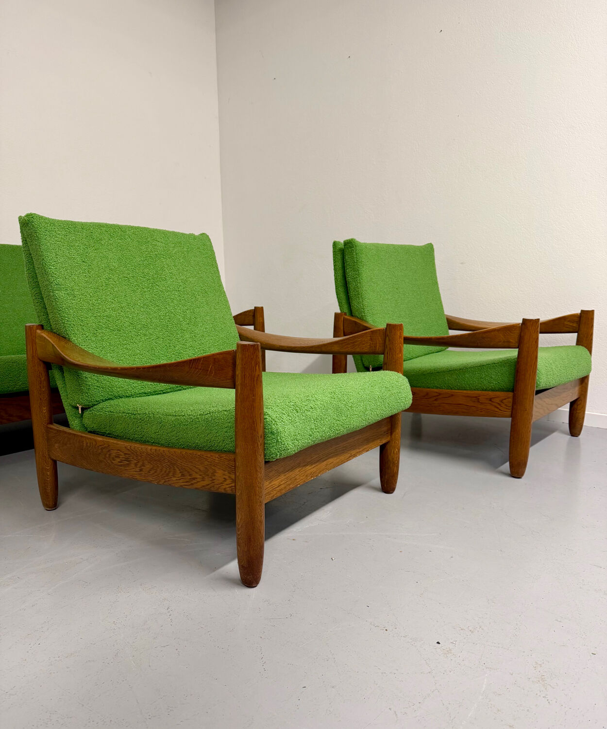 Living room sofa and Scandinavian design armchairs from the 1960s in green boucle.