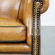 Cognac-colored sheep leather armchair finished with decorative nails