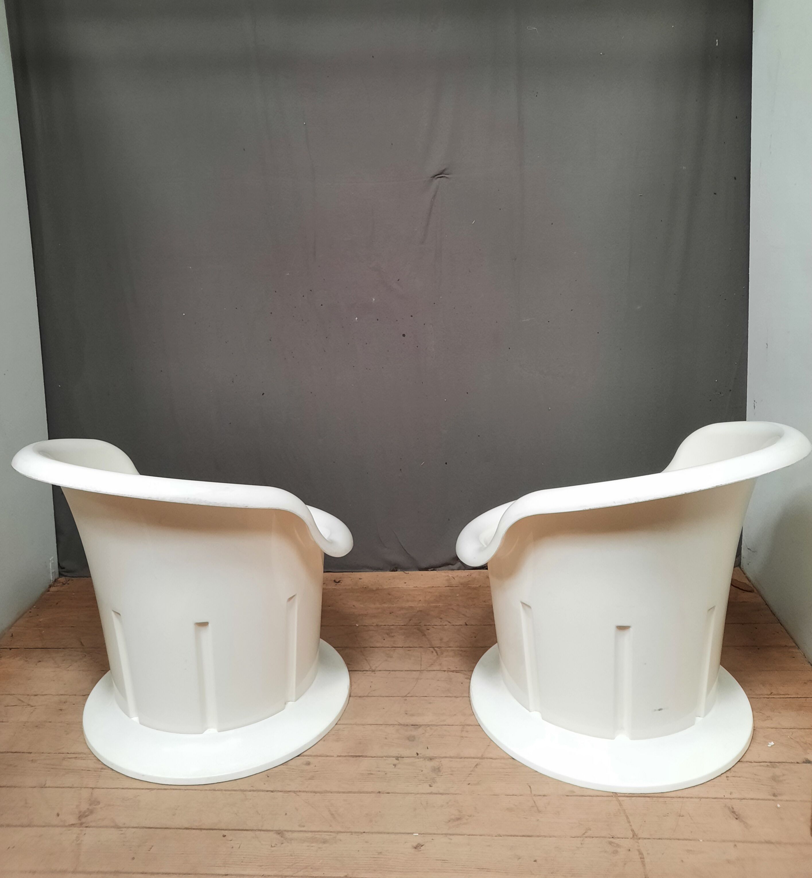 Pair of white plastic armchairs