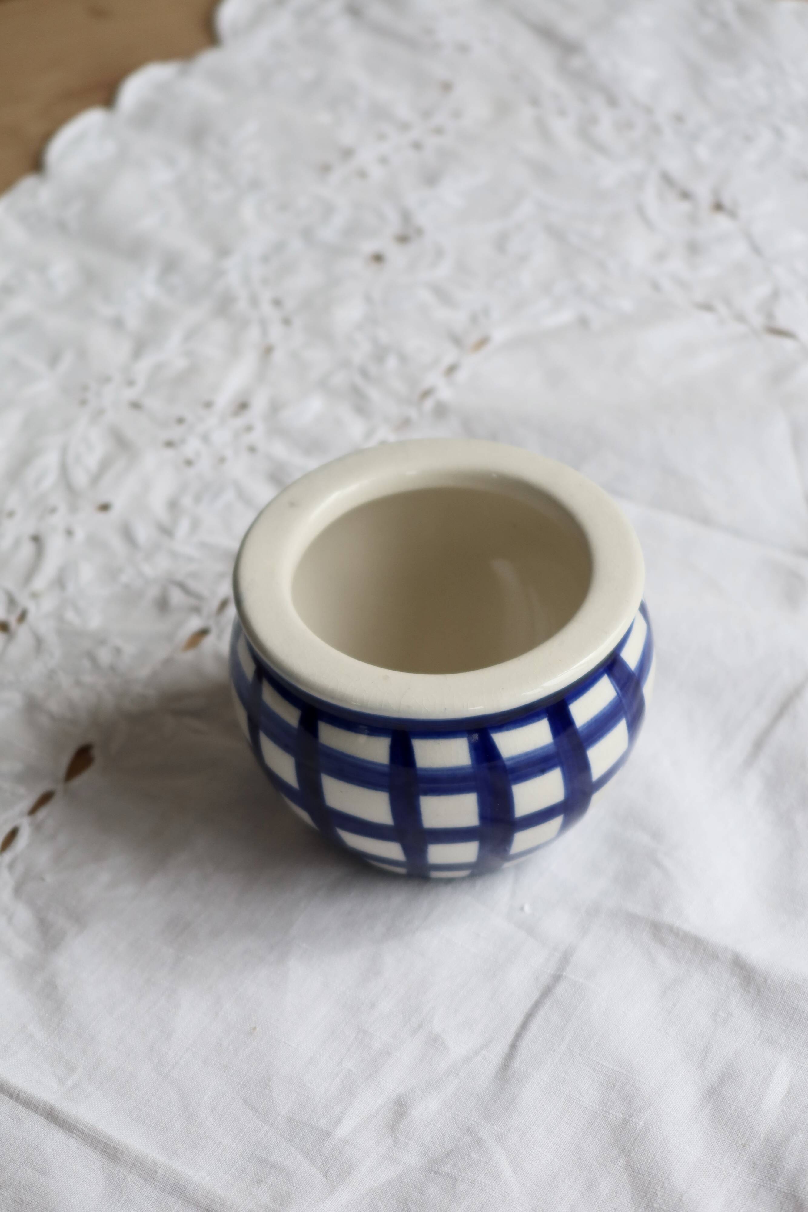Vintage ceramic cache-pot with navy blue gingham pattern.