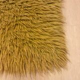 Large handmade wool rug from the 70s in lime green.