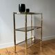 Brass and smoked glass library shelves