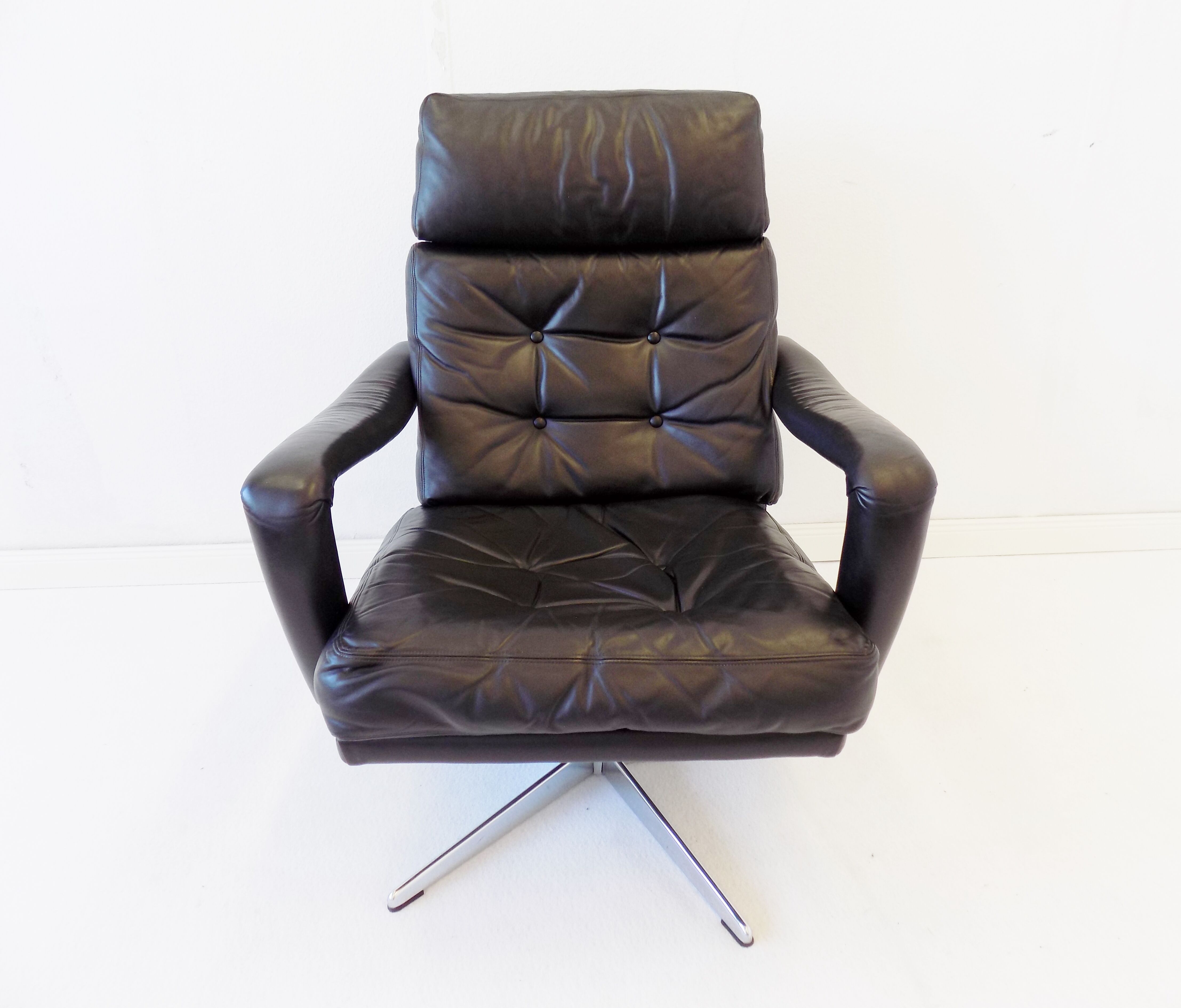 Danish black leather armchair with ottoman 70s