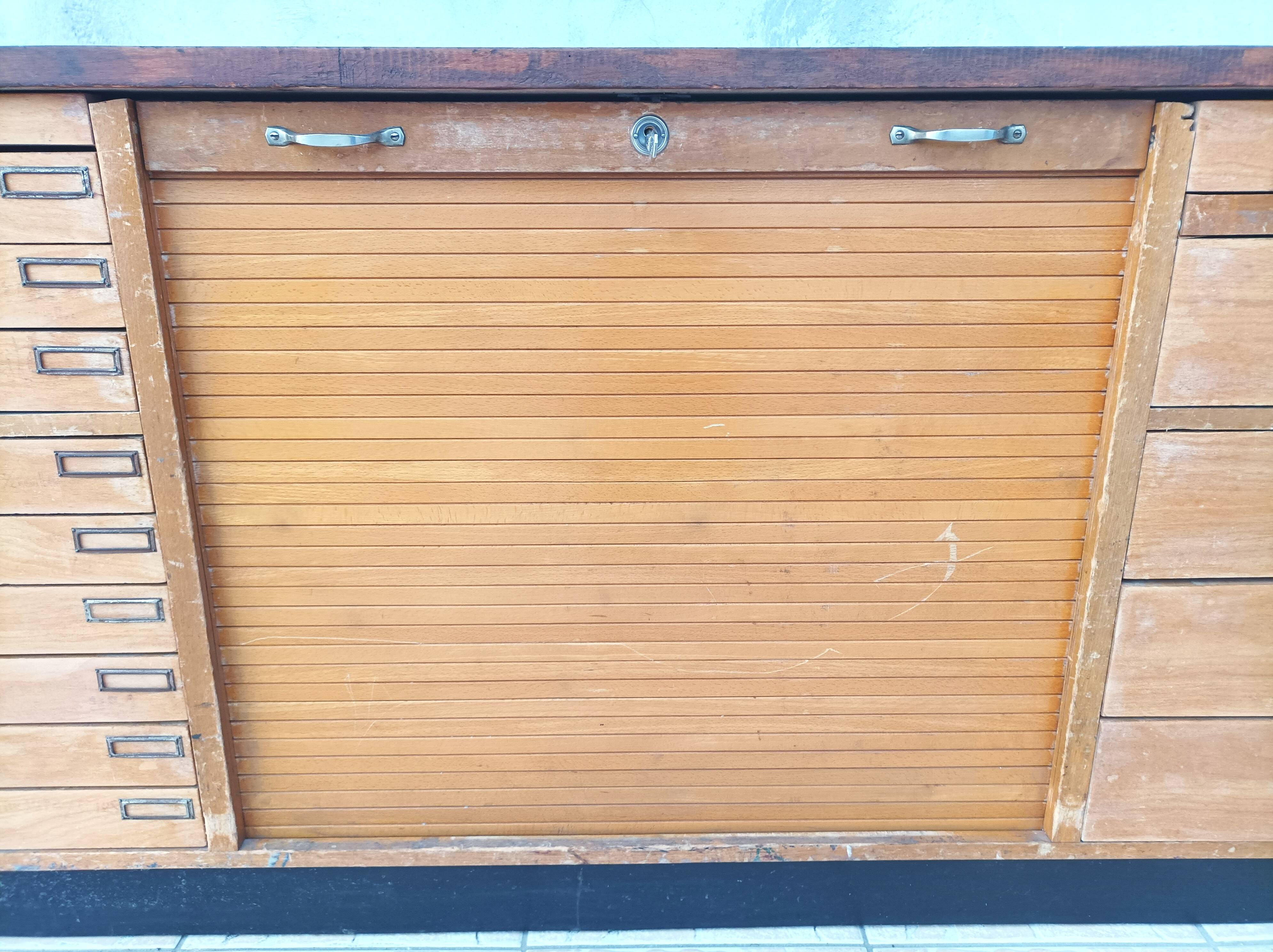 Workshop furniture with drawers and curtain in beech and walnut.