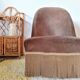 Brown velvet crapaud armchair with fringes and sculpted legs.