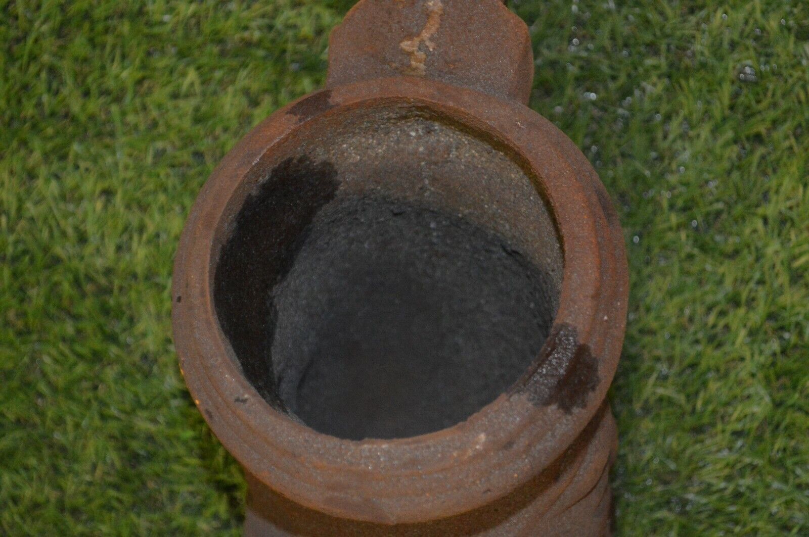 Cast iron gutter downspout in the shape of a dolphin