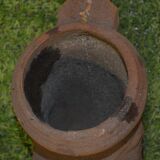 Cast iron gutter downspout in the shape of a dolphin