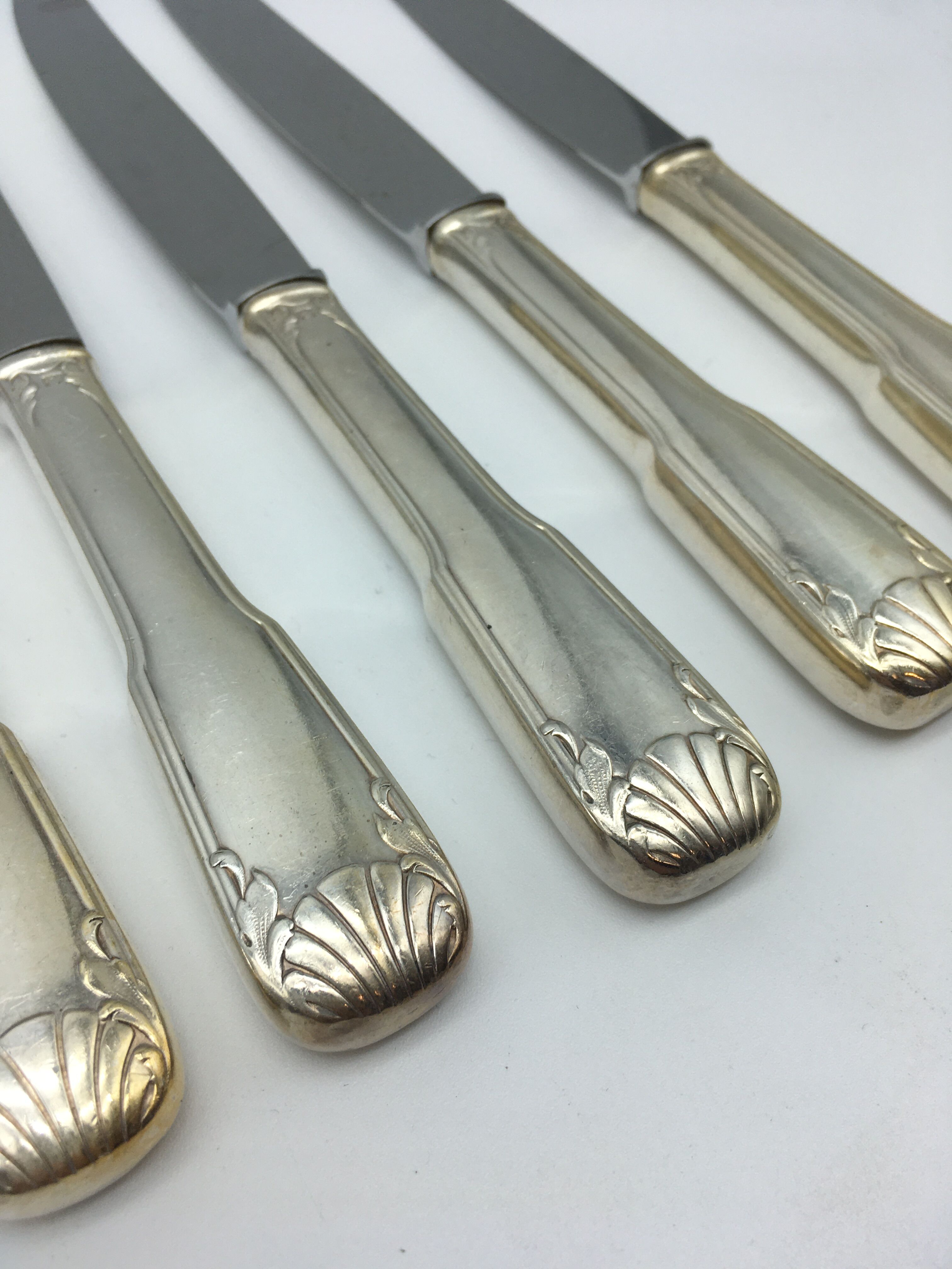 12 silver metal knives.