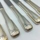 12 silver metal knives.