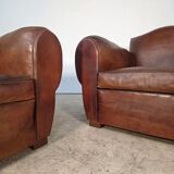 Important pair of Havana leather club armchairs, moustache models, mid-20th century.