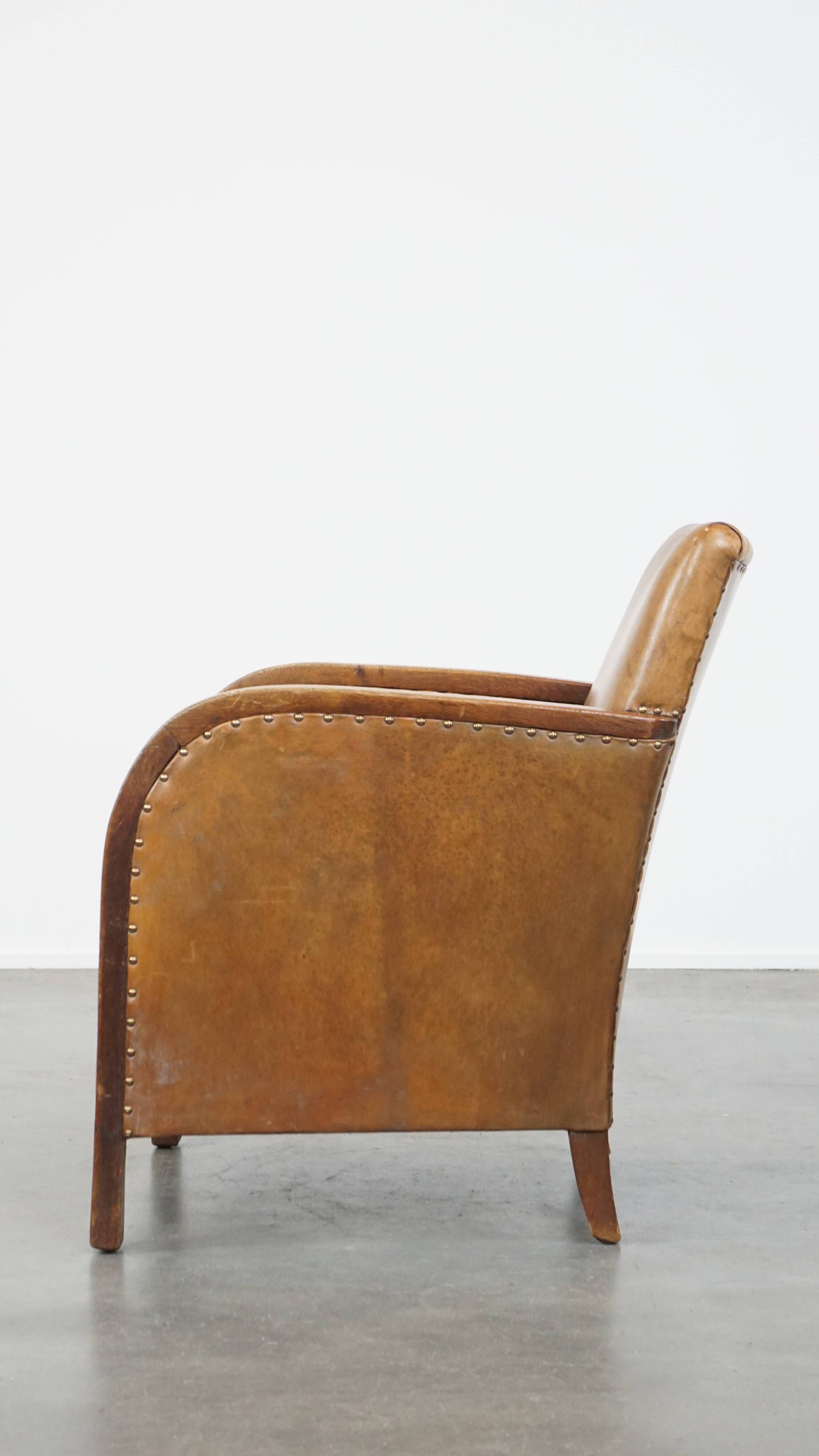 Cognac-colored sheepskin and wooden Art Deco design armchair