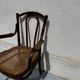 Thonet armchair stamped with curved wooden armrests and caning from the 19th century.