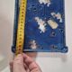 Blue cast iron trivet with flowers, small chip in the paint otherwise very good.