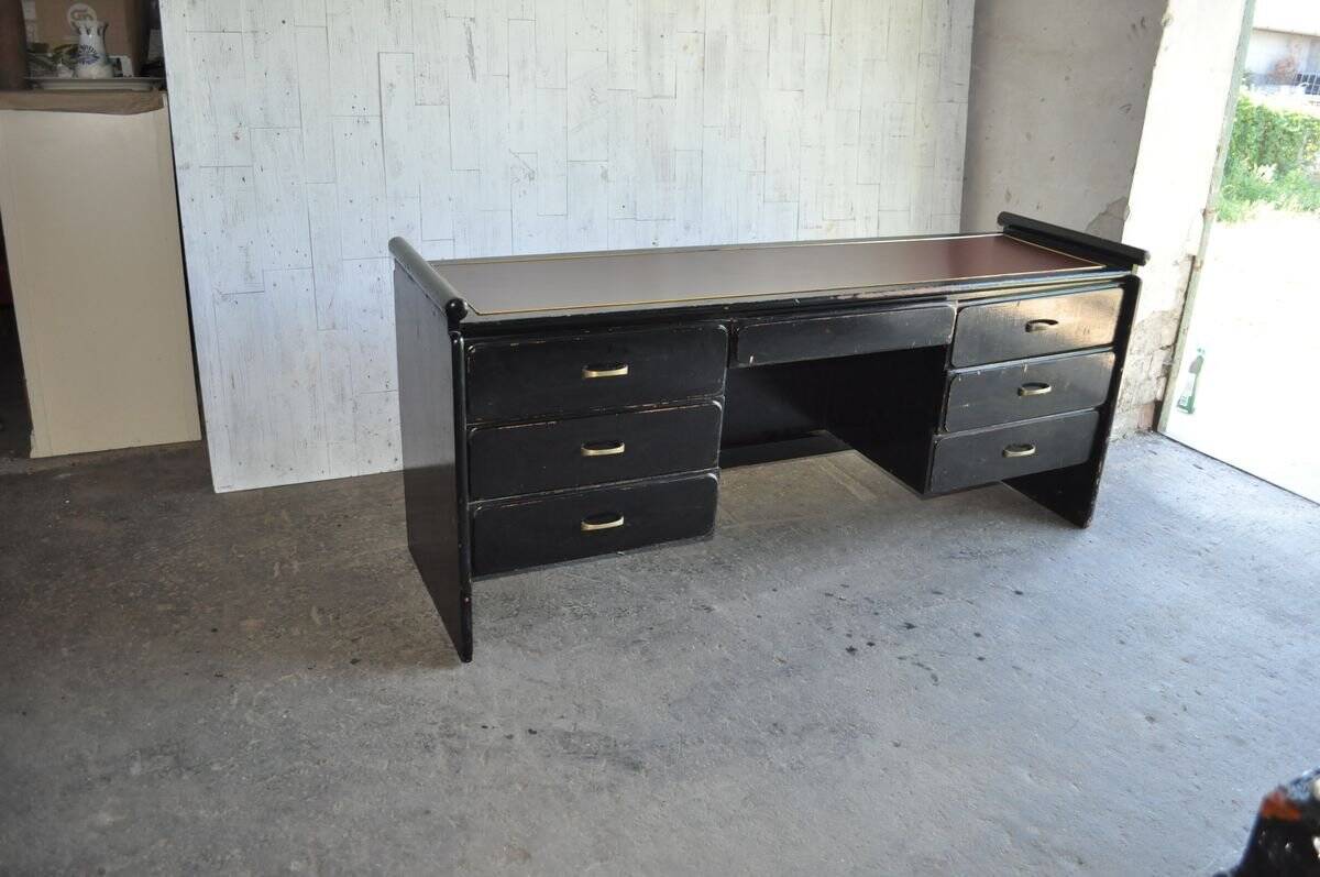 Hungarian Art Deco desk in black painted wood with a brown top and metal handles.