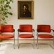 3 vintage chrome metal armchairs with orange fabric tops