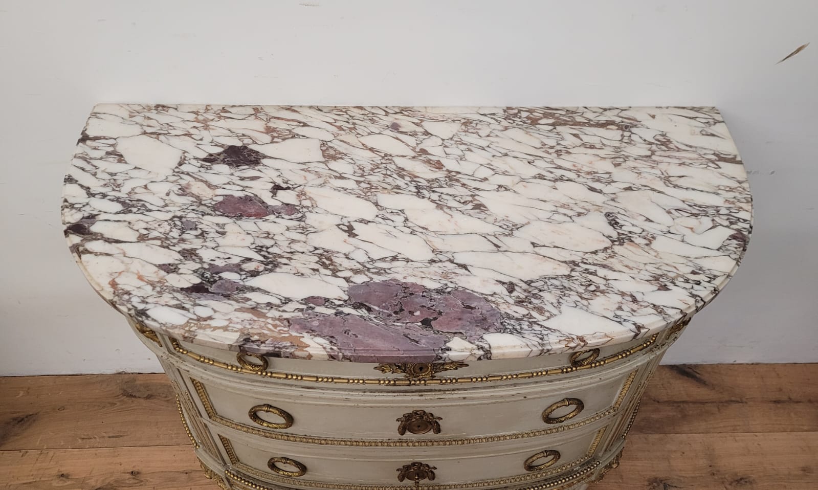 Lacquered half-moon chest of drawers with marble top