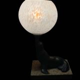 Lamp representing a seal on a marble base