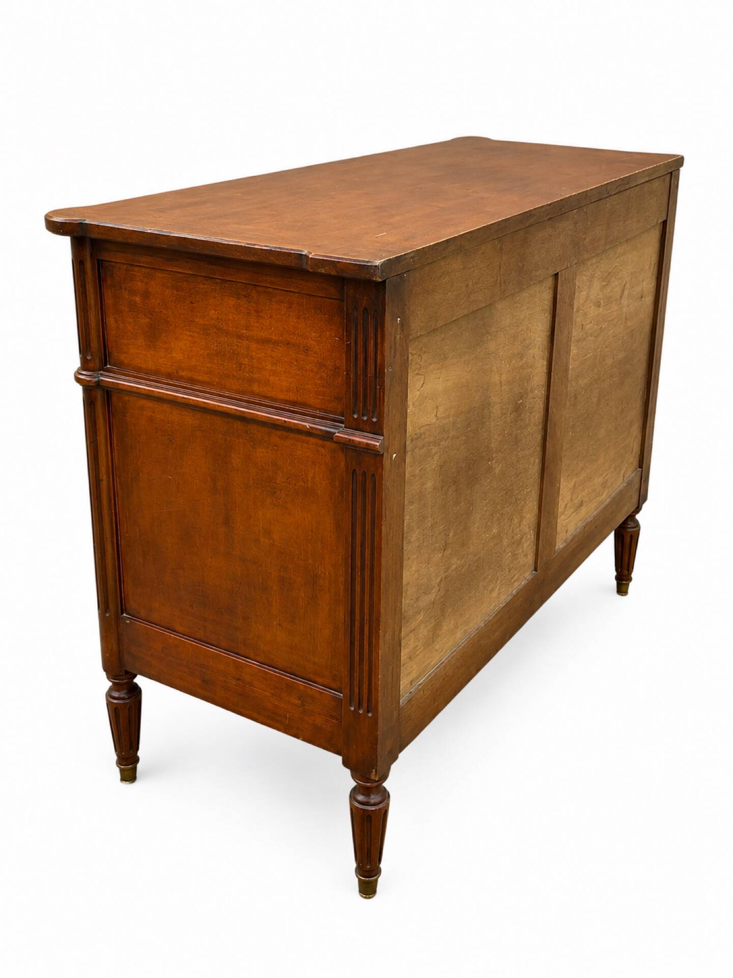 Light walnut commode in Louis XVI style with fluted motifs and three drawers.