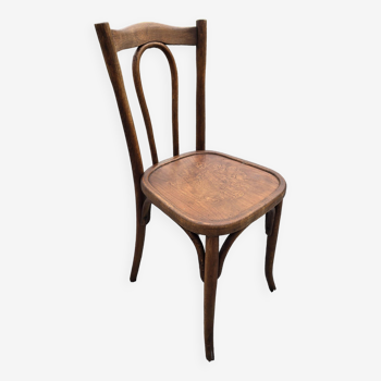 Old bistro chair in curved wood with decorated seat