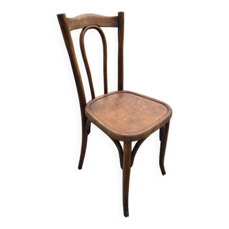 Old bistro chair in curved wood with decorated seat