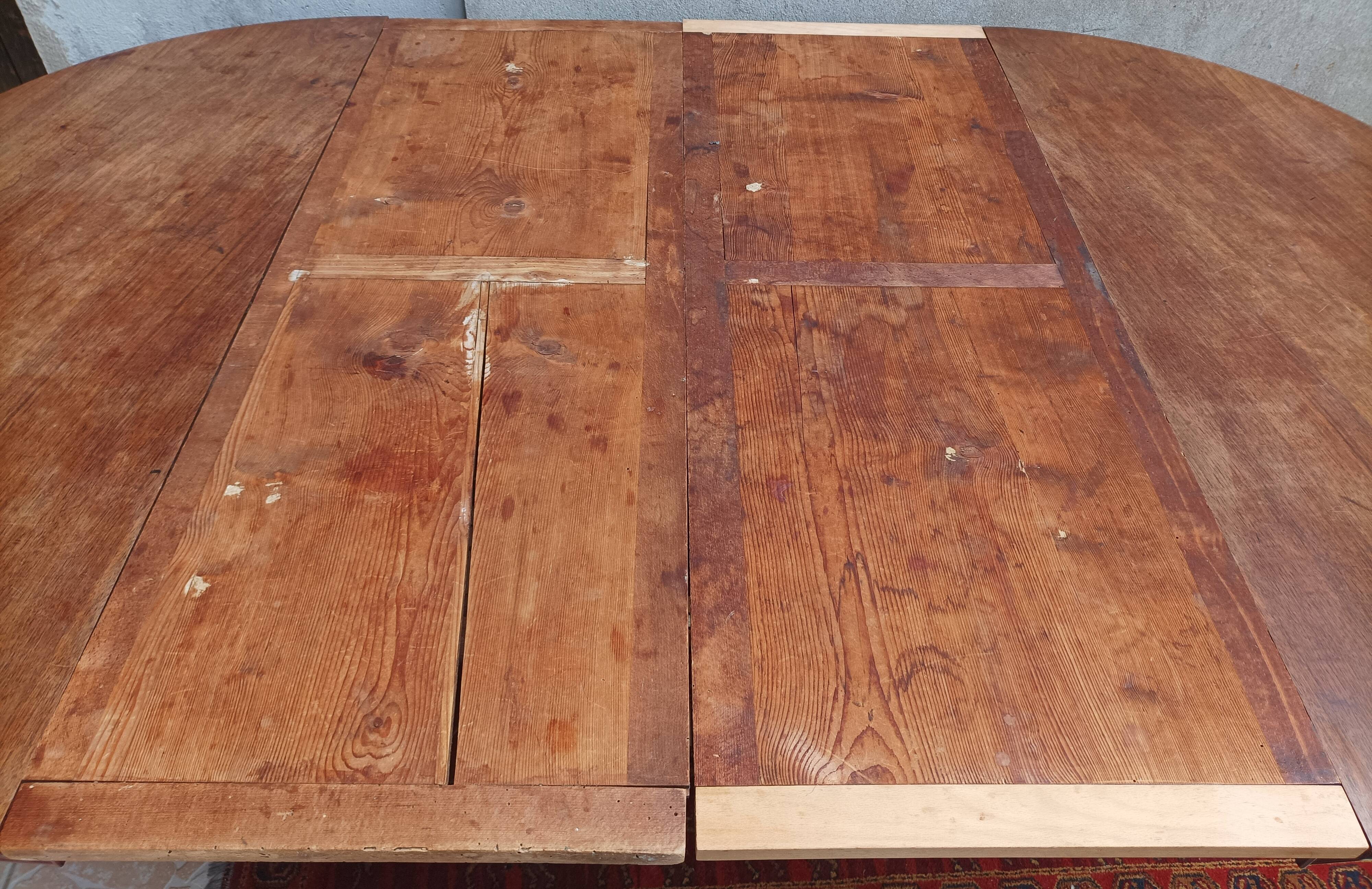 English oval table with 19th century mahogany extensions