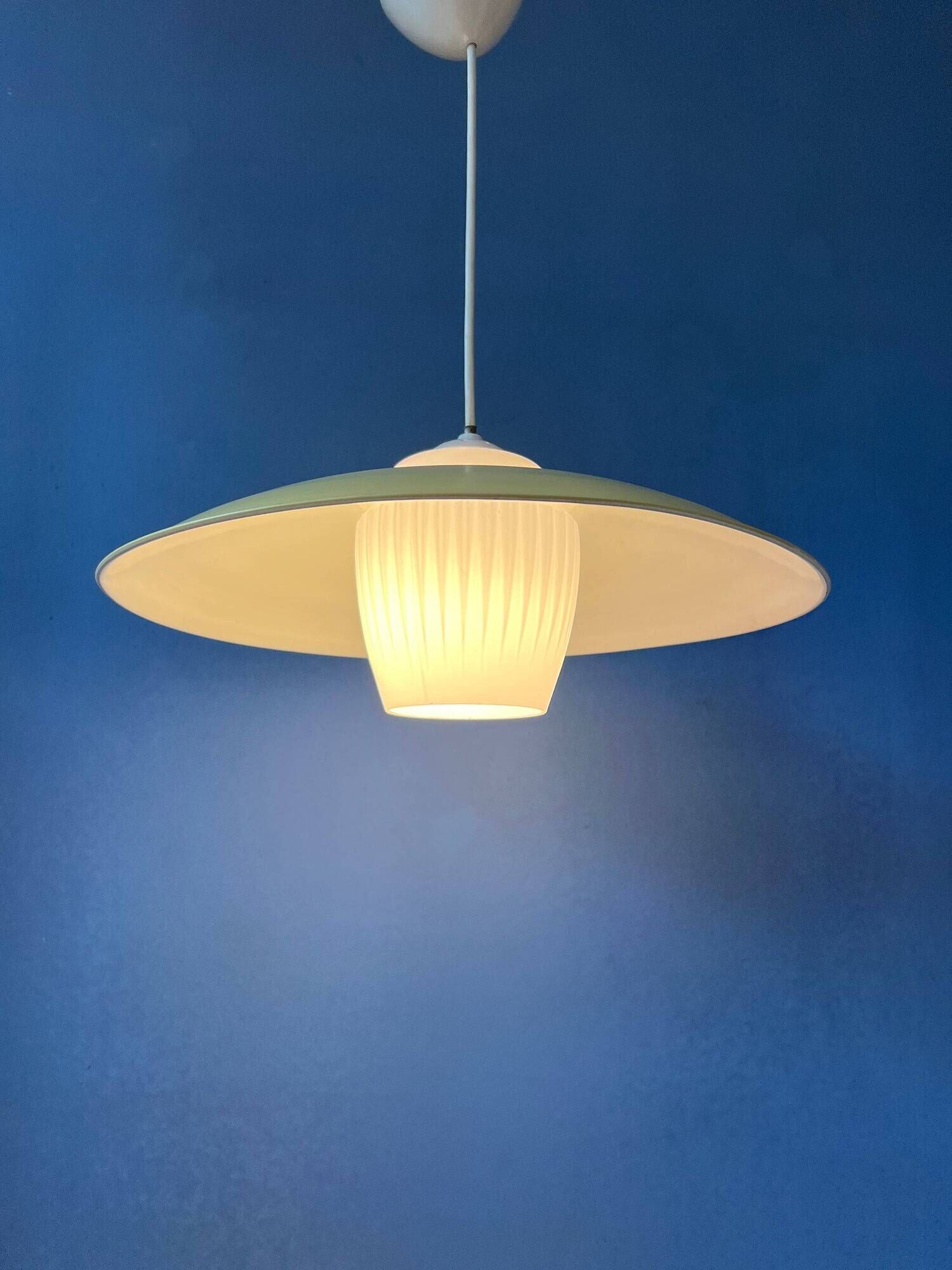 Danish mid-century suspension with opaline glass shade and yellow metal cover.