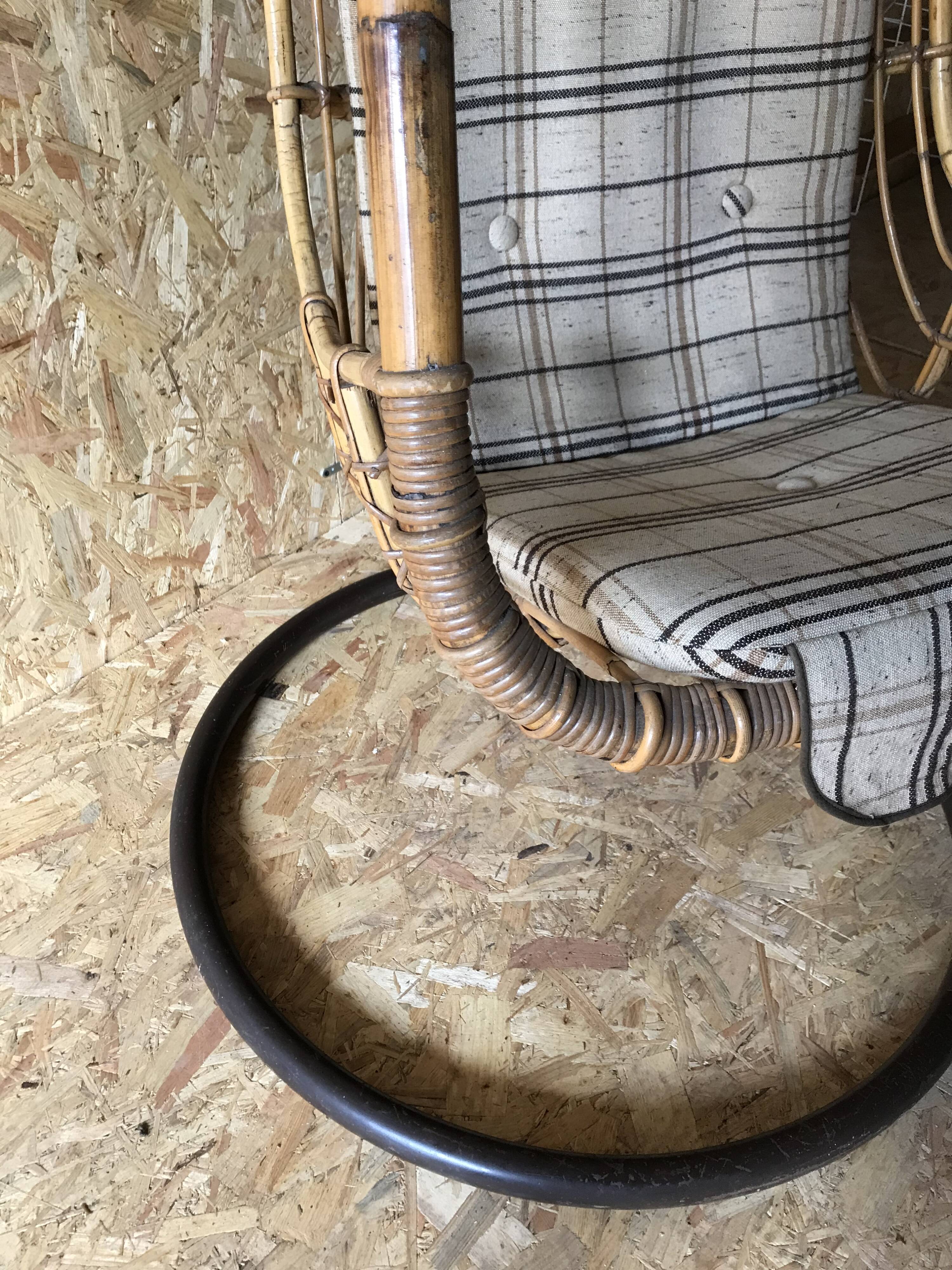 Vintage rattan hanging chair with its stand.