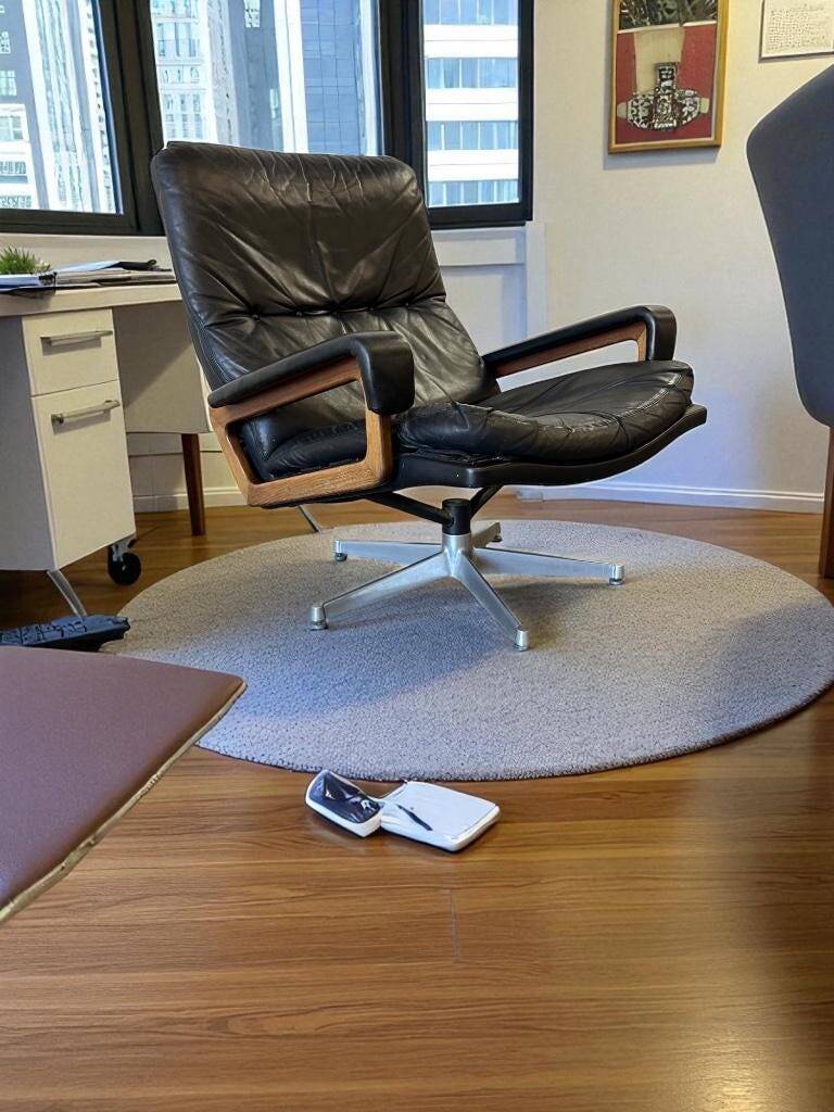 Vintage black leather armchair / Andre Vandenbeuck single seater armchair