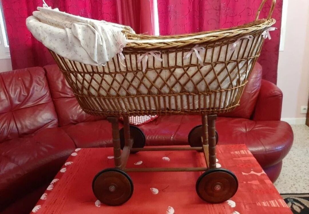 Vintage 1970s wicker cradle on wheels