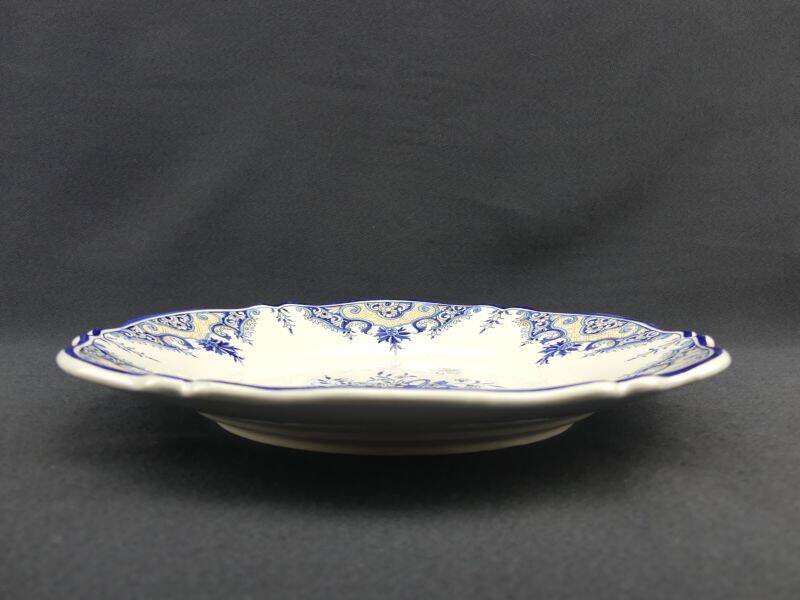 Old earthenware dish with a floral basket decoration.