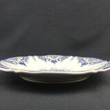 Old earthenware dish with a floral basket decoration.