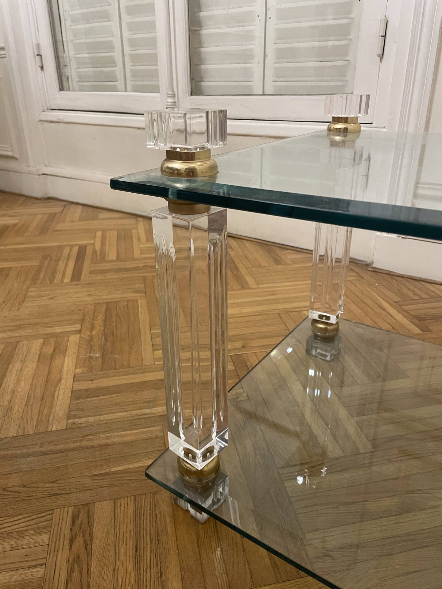 Glass side table with gold decorations.
