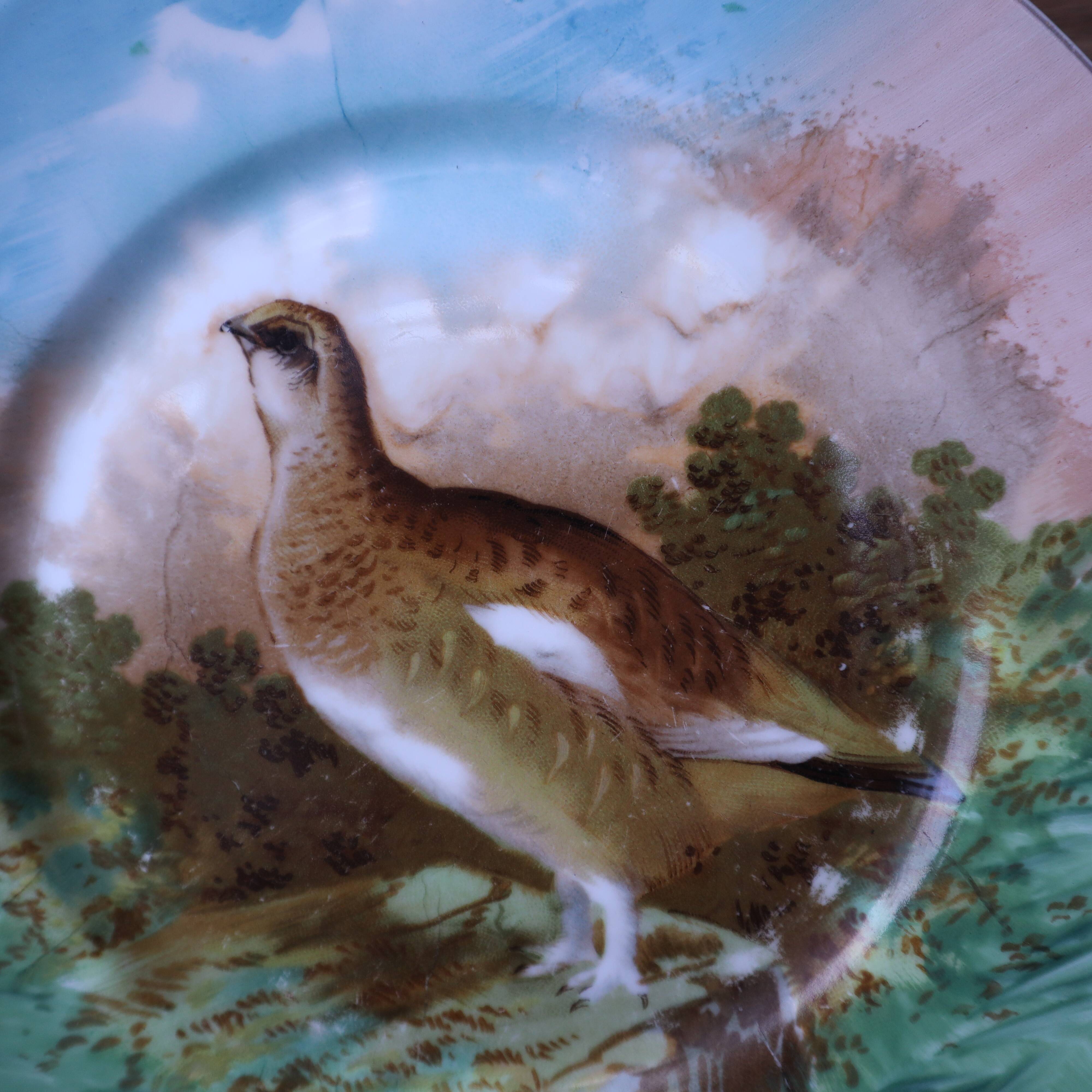 3 decorative porcelain plates from Limoges featuring partridges and pheasants.