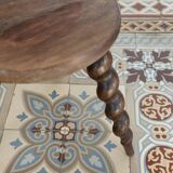 Antique tripod stool made of turned wood.