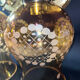 Pair of vintage wall sconces in brass with amber glass globes.
