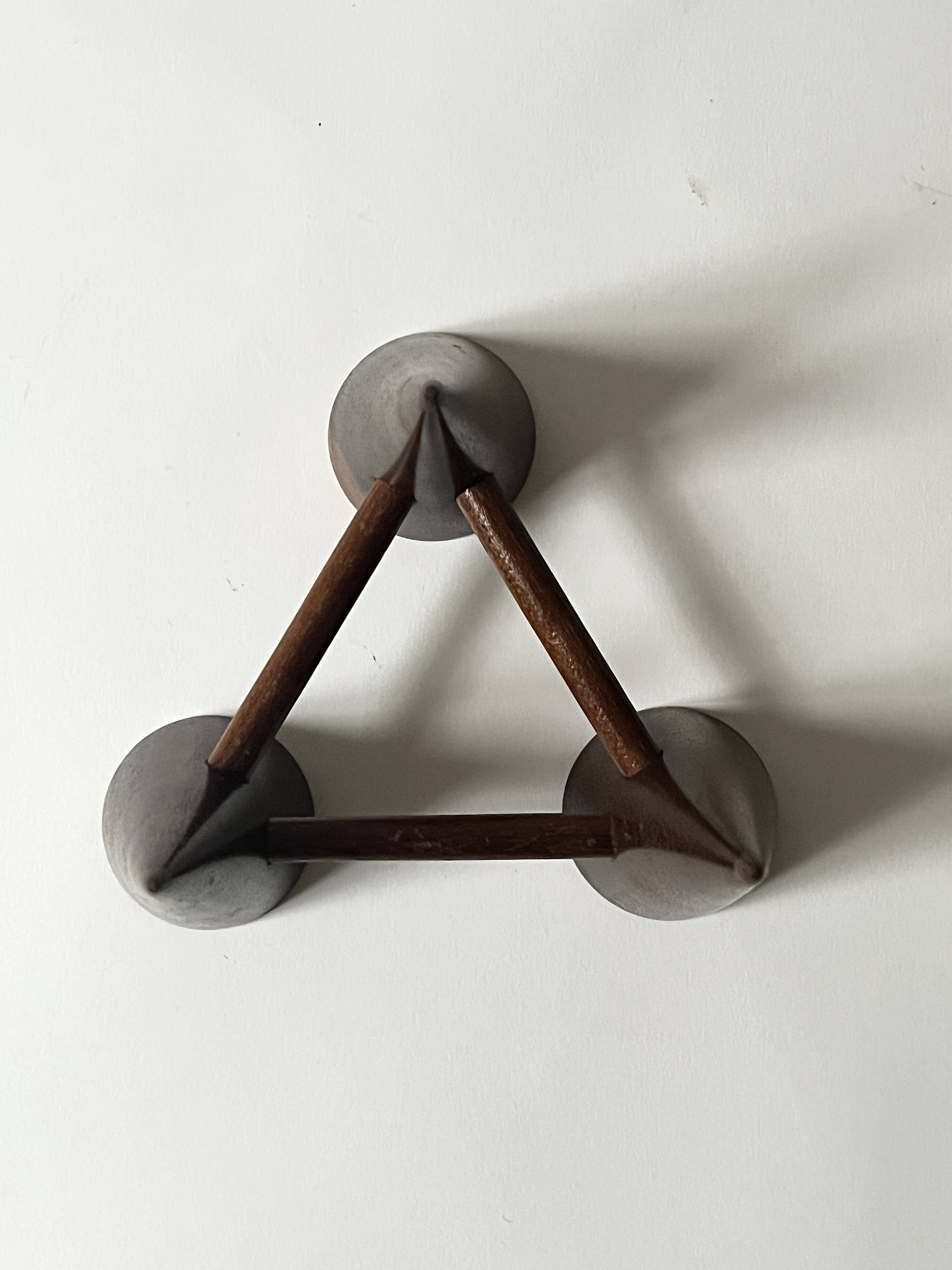 Scandinavian tripod candle holder in carved wood, design from around 1970.