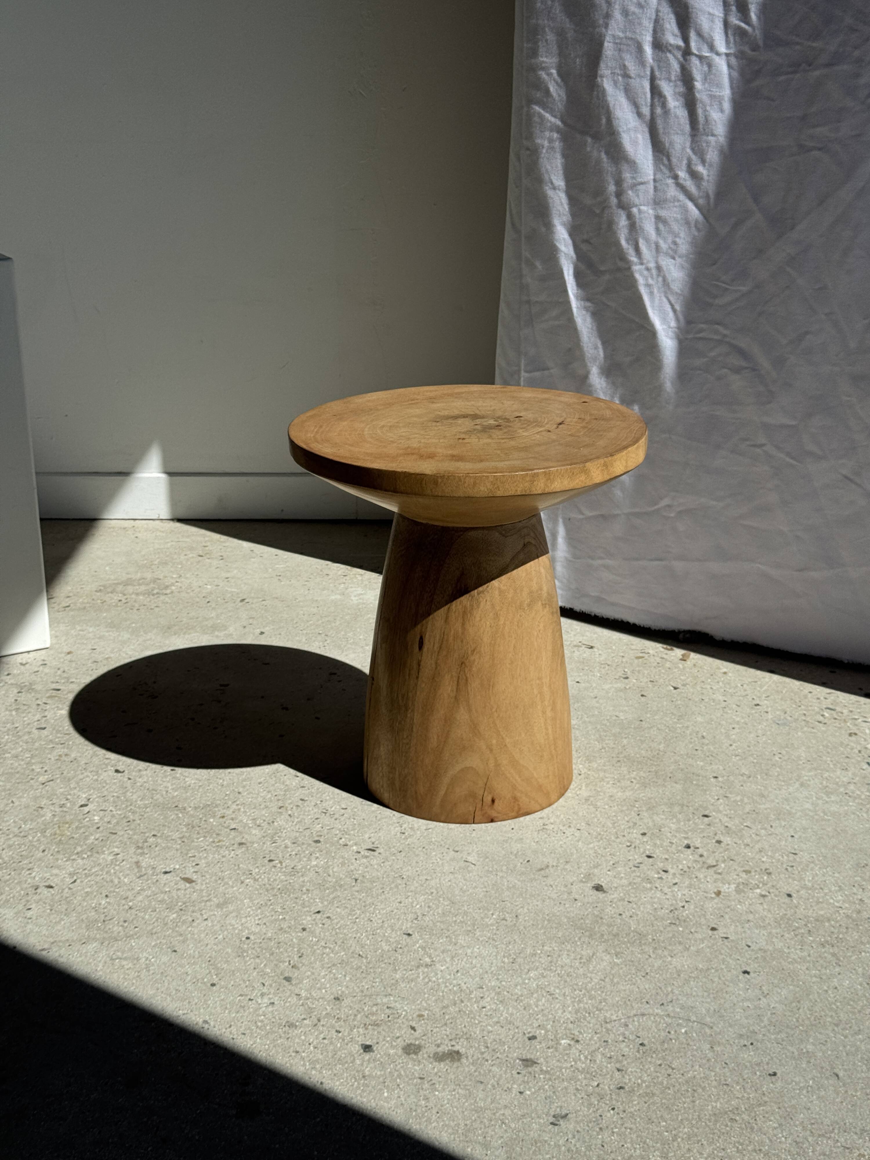Natural solid mango side table (monoxyle) with conical legs.