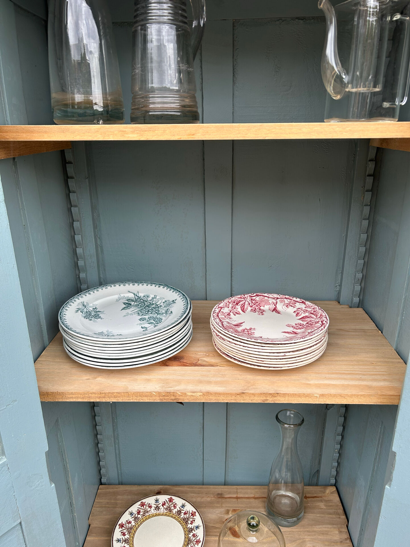 Small antique wardrobe with a faded white patina.