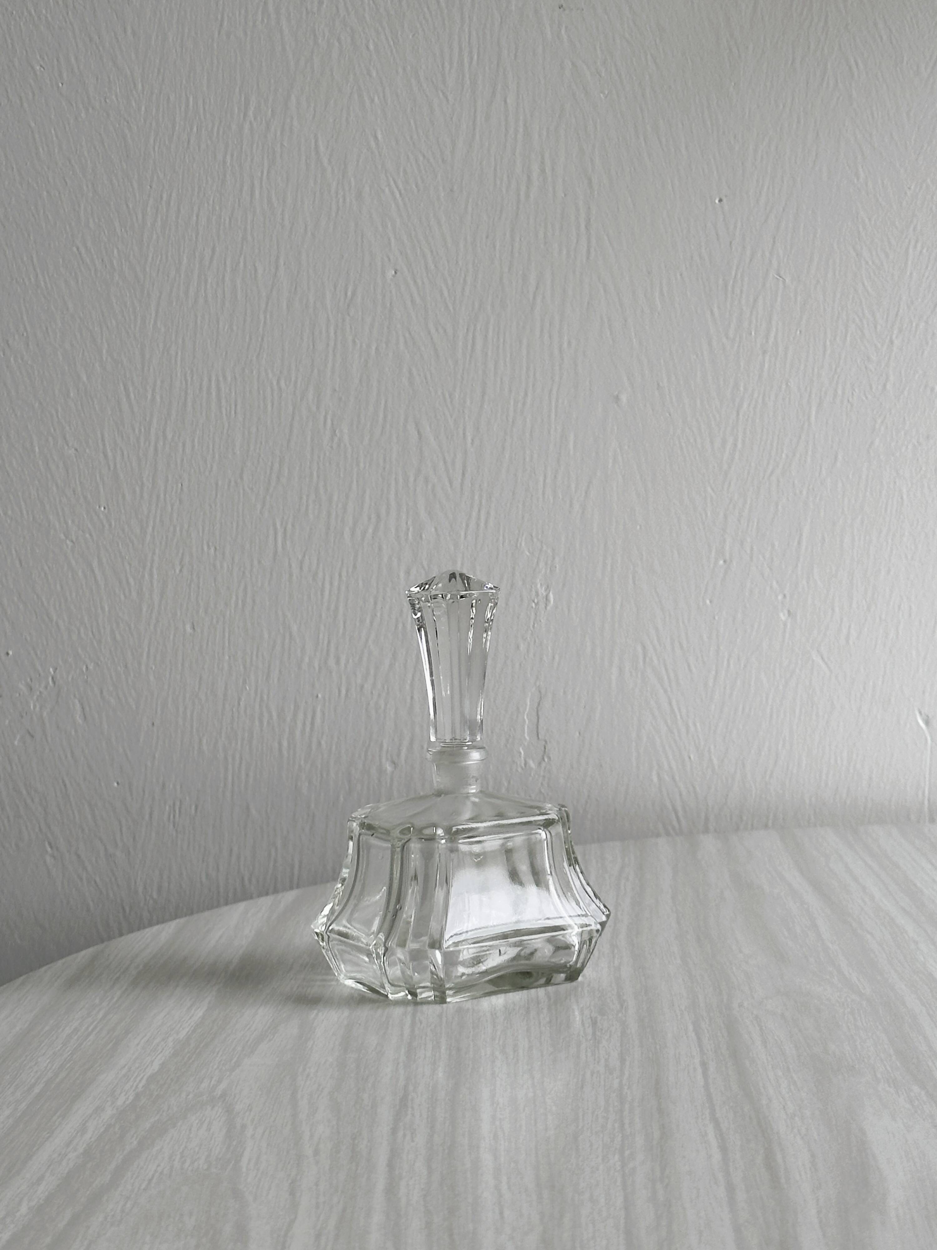 Small transparent faceted glass bottle