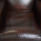 Comfortable wingback chair in English style made of cowhide leather