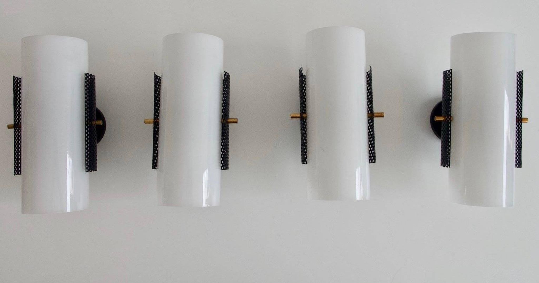Set of four wall lights in white plexiglass and perforated black metal.