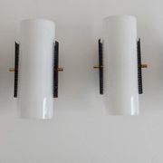 Set of four wall lights in white plexiglass and perforated black metal.