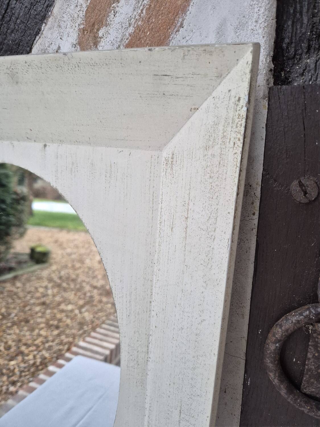 Oval mirror with a distressed white frame