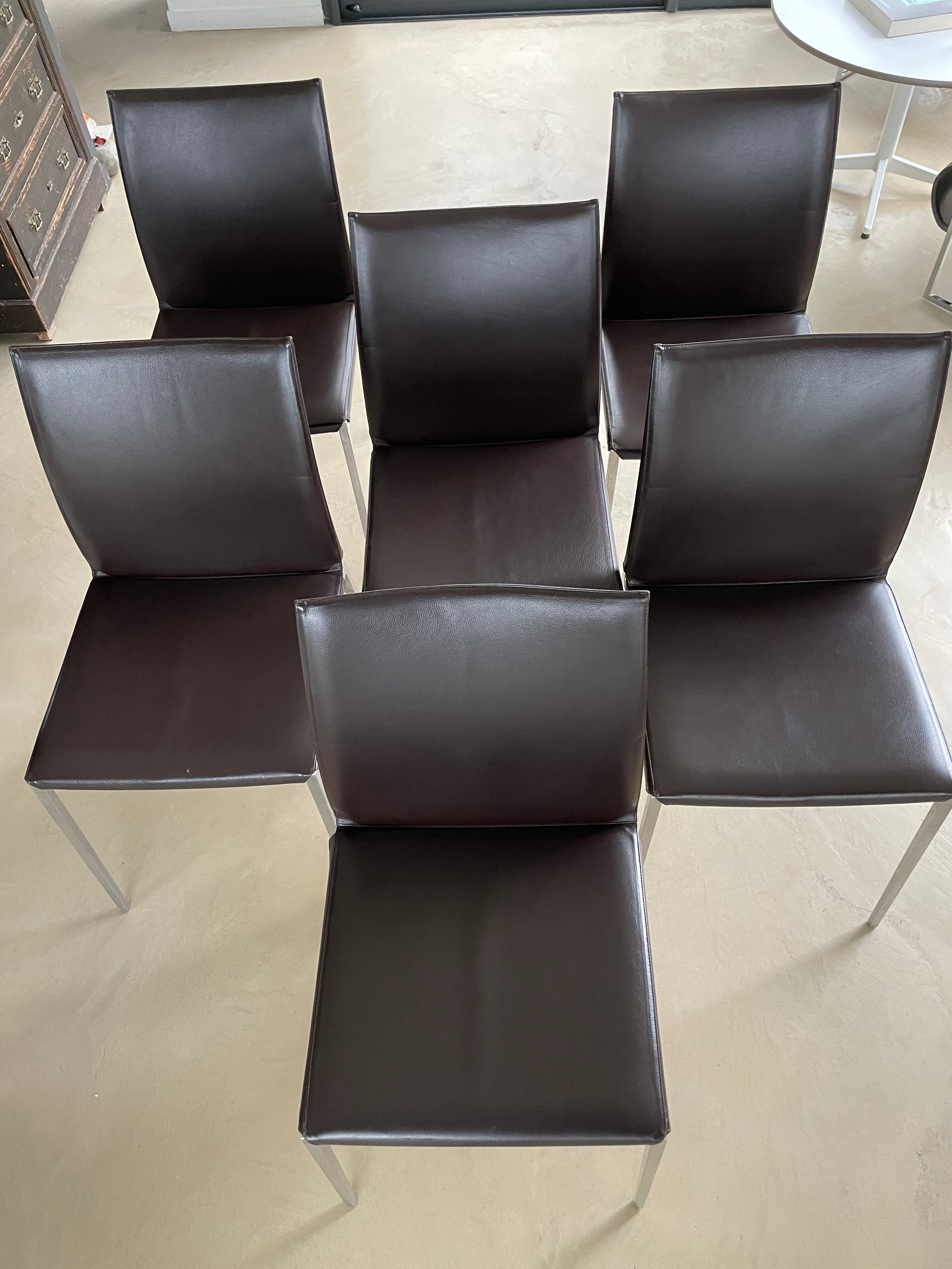 Brown leather chairs and Zanotta metal legs