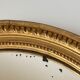 Oval mirror in carved wood, stuccoed and gilded with leaf Louis XVI style late nineteenth century
