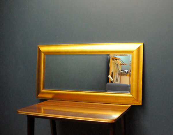 Large mirror in a golden decorative frame