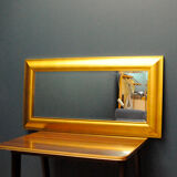 Large mirror in a golden decorative frame