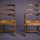 Pair of rustic antique armchairs in wood and woven straw.